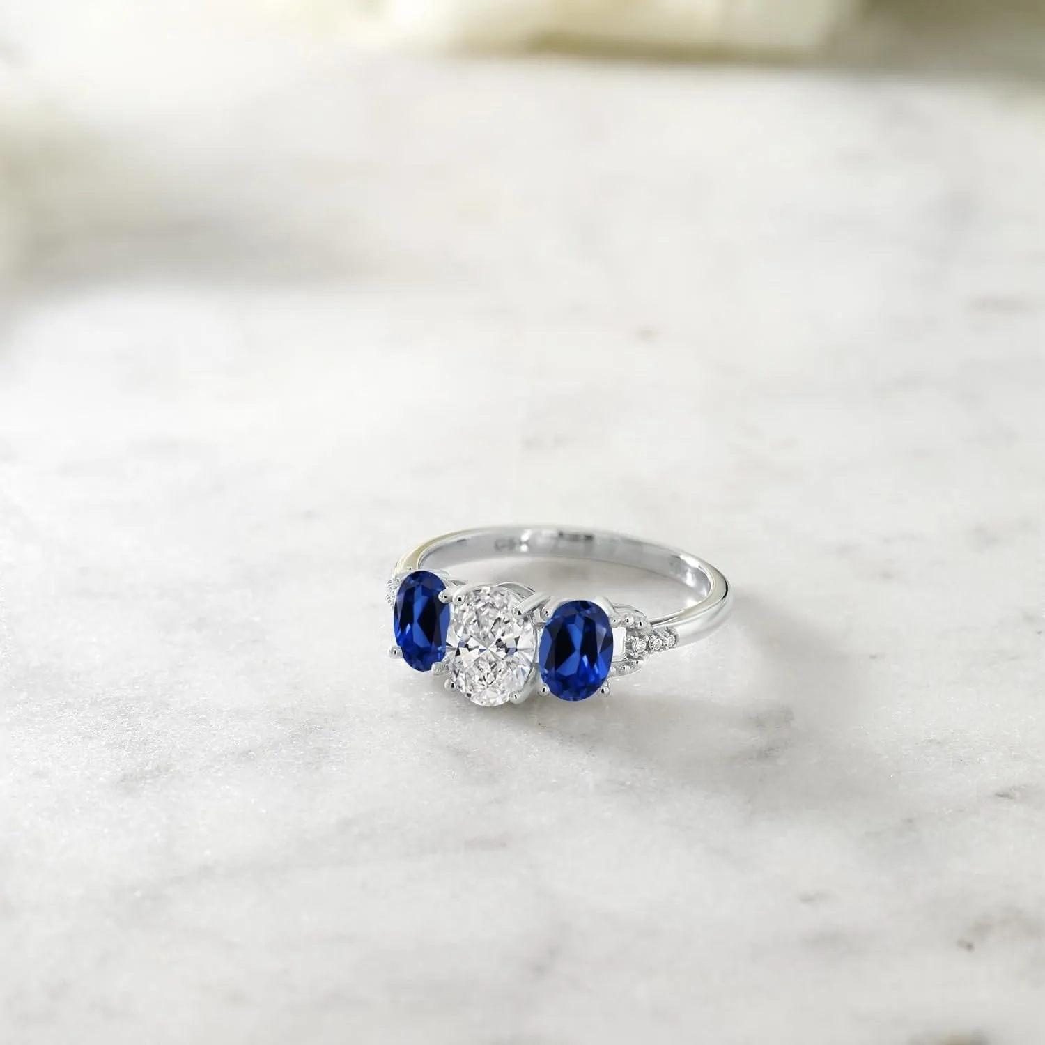 Gem Stone King 2.22 Cttw 10K White Gold IGI Certified Lab Grown Diamond and Blue Created Sapphire 3-Stone Engagement Ring | Center Oval Diamond 1.00 Ct | E-F Color | VS1-VS2 Clarity | Size 5,6,7,8,9